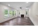 Bright living area featuring wood floors, fireplace, and natural light streaming through multiple windows at 632 Angus Ct, Sanford, NC 27332