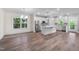Open-concept living space with kitchen, stainless appliances, island, and wood flooring at 632 Angus Ct, Sanford, NC 27332