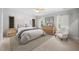 Serene bedroom features a tufted headboard, natural light, and neutral tones for a relaxing atmosphere at 632 Angus Ct, Sanford, NC 27332