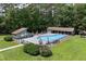 Aerial view of the community pool with covered picnic areas and lush landscaping, perfect for relaxation at 632 Angus Ct, Sanford, NC 27332
