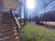 Staircase leading to a covered front porch with black metal railings and a lush lawn at 632 Angus Ct, Sanford, NC 27332