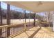 Inviting covered porch features wood floors, dark metal railings, and a ceiling fan at 632 Angus Ct, Sanford, NC 27332