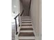 Modern staircase design with wood treads, white risers, and a sleek black metal railing at 632 Angus Ct, Sanford, NC 27332