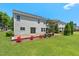 A backyard features a beautiful lawn, a cozy patio area, and charming landscaping for outdoor enjoyment at 634 Conover Rd, Durham, NC 27703