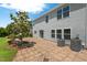 A patio area and a grassy lawn surrounding the home offer multiple outdoor relaxation and entertainment options at 634 Conover Rd, Durham, NC 27703