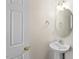 Small bathroom with pedestal sink, oval mirror, and decorative light fixture at 634 Conover Rd, Durham, NC 27703