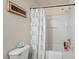 Functional bathroom featuring a toilet and shower with a paisley patterned curtain at 634 Conover Rd, Durham, NC 27703