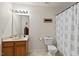 Functional bathroom featuring a single sink vanity, toilet, and shower with a curtain at 634 Conover Rd, Durham, NC 27703