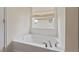 Close up of a white bathtub with chrome faucet, by a window at 634 Conover Rd, Durham, NC 27703