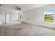 Spacious carpeted bedroom with ceiling fan and large windows offering abundant natural light at 634 Conover Rd, Durham, NC 27703