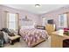 Comfortable bedroom with a window and closet, featuring a bed with a floral patterned quilt at 634 Conover Rd, Durham, NC 27703