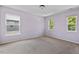 Cozy bedroom with three bright windows, filled with natural light and outside views at 634 Conover Rd, Durham, NC 27703