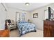Cozy bedroom with a window and closet, featuring a bed with a patterned blue and white quilt at 634 Conover Rd, Durham, NC 27703