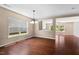 Open dining space featuring hardwood floors, large windows, and modern chandelier at 634 Conover Rd, Durham, NC 27703