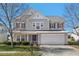Charming two-story home with a well-maintained lawn, inviting curb appeal, and attached garage at 634 Conover Rd, Durham, NC 27703
