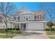 Charming two-story home features a well-manicured lawn, inviting entrance, and a two car garage at 634 Conover Rd, Durham, NC 27703