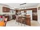 Spacious kitchen with brown cabinetry, stainless steel appliances, and a functional island with barstool seating at 634 Conover Rd, Durham, NC 27703