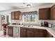 A close up view of the stainless steel sink and window that looks out into the backyard at 634 Conover Rd, Durham, NC 27703