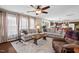 Spacious living room with ceiling fan, large windows, and seamless flow to the kitchen at 634 Conover Rd, Durham, NC 27703