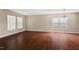 Spacious living area with hardwood flooring and modern lighting fixture at 634 Conover Rd, Durham, NC 27703