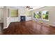 Cozy living area with hardwood floors, a fireplace, and custom built-in shelving at 634 Conover Rd, Durham, NC 27703