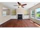 Bright living room features a fireplace, built-in shelves, ceiling fan, and natural light from the windows at 634 Conover Rd, Durham, NC 27703
