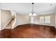 Inviting living room showcasing hardwood floors, an open staircase, and large windows at 634 Conover Rd, Durham, NC 27703