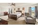 Serene main bedroom with a ceiling fan, large windows, and carpet for comfort and style at 634 Conover Rd, Durham, NC 27703