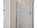 White shower stall with built-in shelving and transparent sliding doors at 634 Conover Rd, Durham, NC 27703