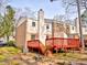 Townhome with backyard and red deck, exterior brick, and chimney at 6525 New Market Way, Raleigh, NC 27615