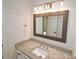 Updated bathroom features granite countertop, large mirror, and modern lighting at 6525 New Market Way, Raleigh, NC 27615