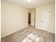 Neutral bedroom features carpet, a ceiling light and access to an en-suite bathroom at 6525 New Market Way, Raleigh, NC 27615