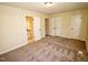 Neutral bedroom features carpet, a ceiling light and access to an en-suite bathroom at 6525 New Market Way, Raleigh, NC 27615