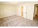 Bright bedroom with neutral carpet, fresh paint and a view into the en-suite bathroom at 6525 New Market Way, Raleigh, NC 27615