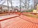 Spacious red wood deck with multiple townhomes in the background at 6525 New Market Way, Raleigh, NC 27615