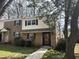 Traditional townhouse featuring brick facade, neutral siding, dark shutters, and well-maintained landscaping at 6525 New Market Way, Raleigh, NC 27615