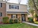 Charming two-story home with brick and siding, complemented by dark shutters and lush landscaping at 6525 New Market Way, Raleigh, NC 27615