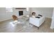Inviting living room with a white-painted brick fireplace, neutral decor, and wood-look flooring at 6525 New Market Way, Raleigh, NC 27615
