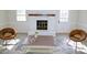 Cozy living room featuring a white-painted brick fireplace, neutral decor, and wood-look flooring at 6525 New Market Way, Raleigh, NC 27615