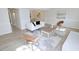 Open-concept living area featuring a fireplace, modern furnishings, and wood-look floors with an adjoining dining area at 6525 New Market Way, Raleigh, NC 27615