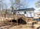 Elevated back deck with stairs, ideal for enjoying outdoor living and views of the property at 7704 Cresthill Ct, Raleigh, NC 27615