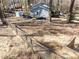 Fenced backyard featuring grass, landscaping, a small wooden shed, and a deck at 7704 Cresthill Ct, Raleigh, NC 27615