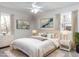 Bedroom featuring a well-made bed, soft decor, and plenty of natural light from two windows at 7704 Cresthill Ct, Raleigh, NC 27615