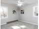 Bright bedroom with neutral walls, carpet, ceiling fan, and two windows providing ample natural light at 7704 Cresthill Ct, Raleigh, NC 27615