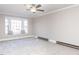 Spacious bedroom with bay window, carpet, ceiling fan, and neutral walls creating a serene atmosphere at 7704 Cresthill Ct, Raleigh, NC 27615