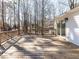 Spacious wooden deck offering a great view of the wooded surroundings and home's rear entry at 7704 Cresthill Ct, Raleigh, NC 27615