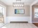 Inviting dining area with modern lighting, neutral walls, and a sliding glass door to the deck at 7704 Cresthill Ct, Raleigh, NC 27615