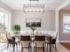 Elegant dining room with stylish furnishings, modern lighting, and a serene view through the window at 7704 Cresthill Ct, Raleigh, NC 27615