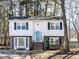 Charming two-story home with brick accents and a well-maintained front yard, nestled among mature trees at 7704 Cresthill Ct, Raleigh, NC 27615