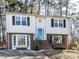 Charming two-story home with a well-manicured lawn, brick accents, and a welcoming entrance at 7704 Cresthill Ct, Raleigh, NC 27615